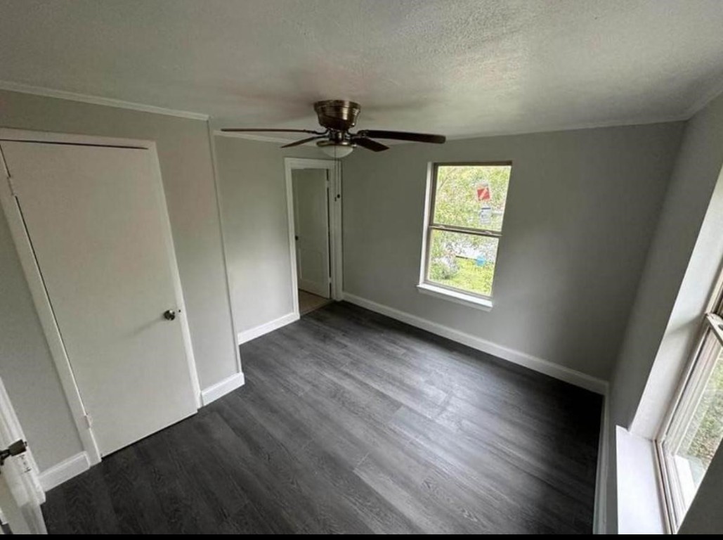 702 Rosedale Street, Unit B La Marque, TX 77568 - Photo 5 of 10 wooden floor in an empty room with a window
