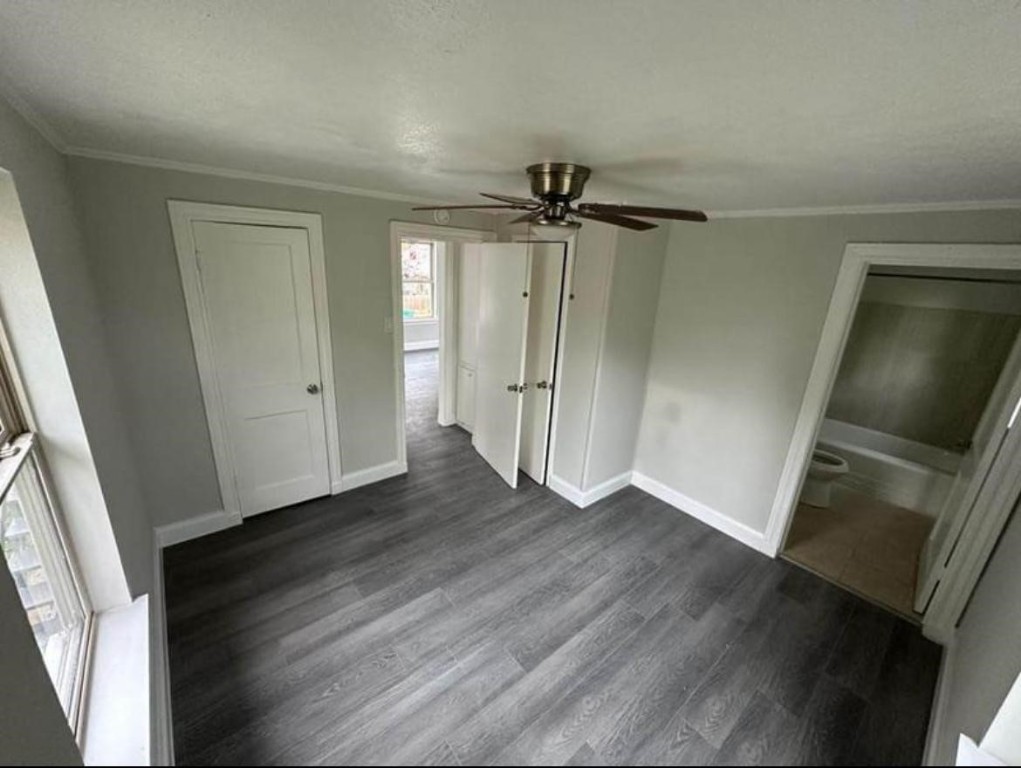 702 Rosedale Street, Unit B La Marque, TX 77568 - Photo 6 of 10 an empty room with wooden floor and a ceiling fan