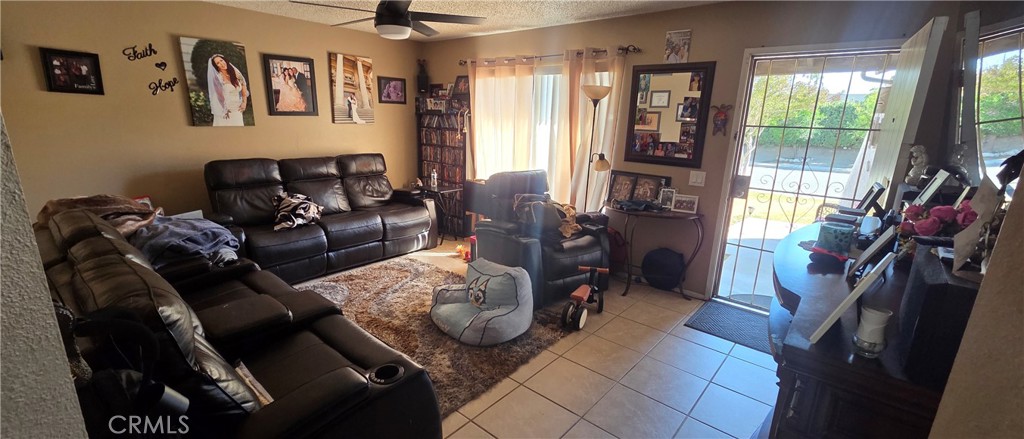 1548 Ranch Road San Bernardino, CA 92407 - Photo 4 of 26 a living room with furniture and a floor to ceiling window