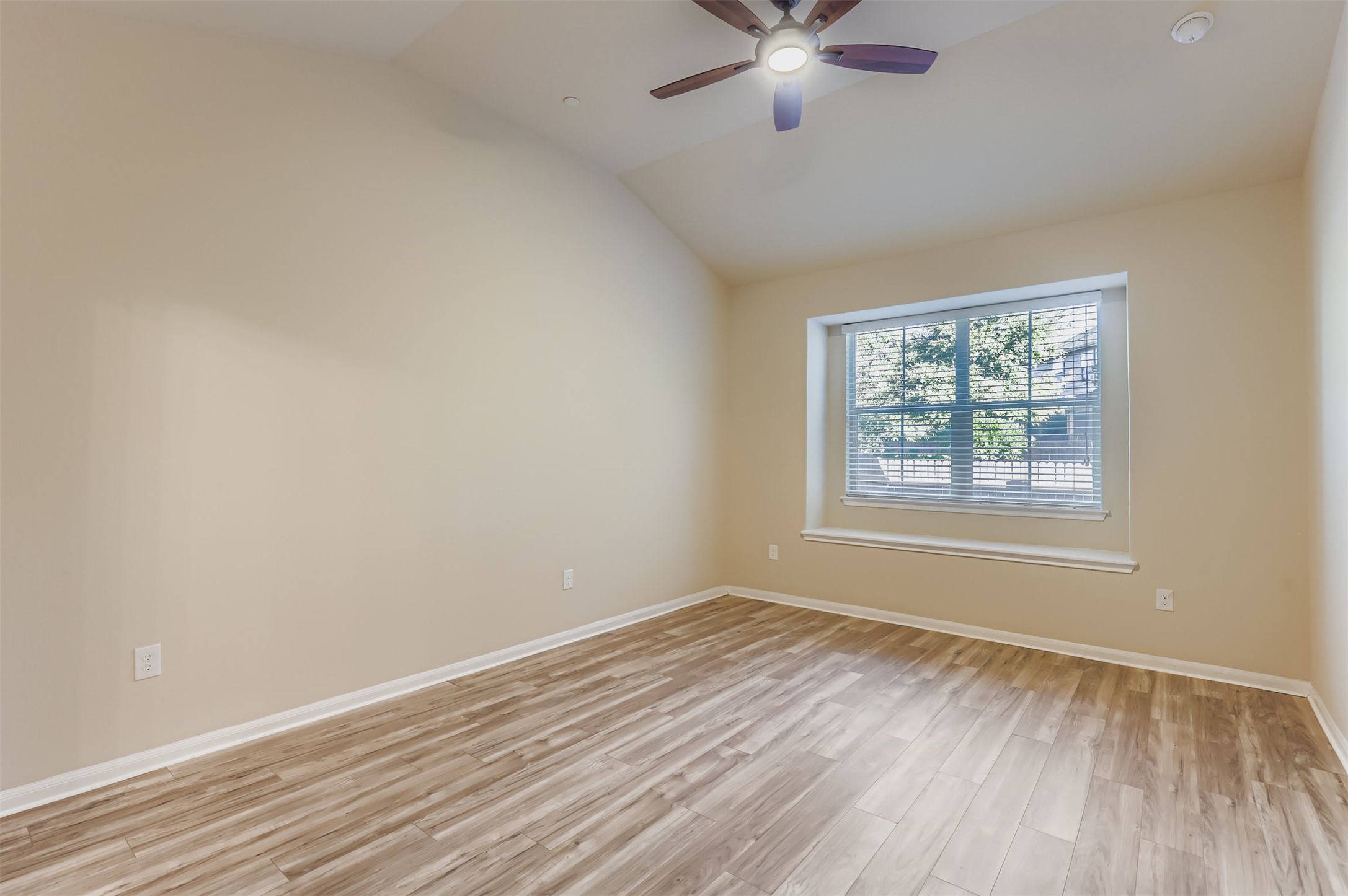 2880 Donnell Drive, Unit 803 Round Rock, TX 78664 - Photo 5 of 11 wooden floor in an empty room with a window