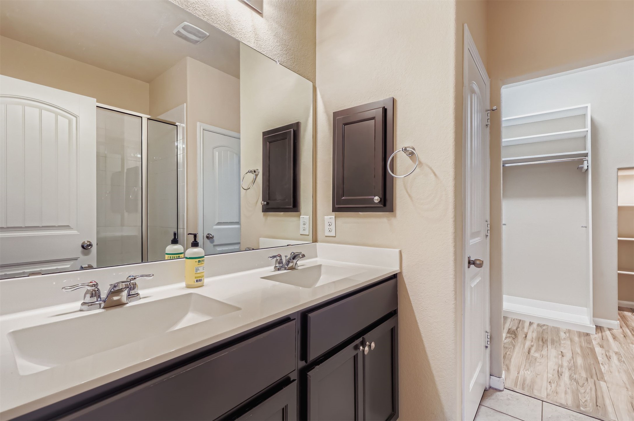 2880 Donnell Drive, Unit 803 Round Rock, TX 78664 - Photo 6 of 11 a bathroom with double sink and a mirror