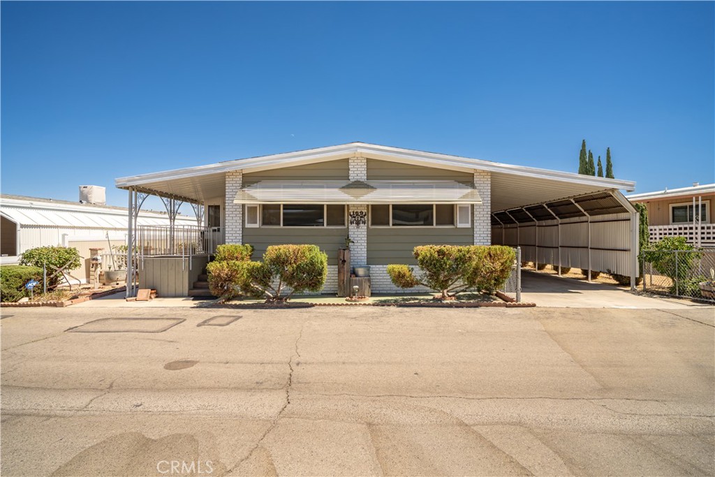 13393 Mariposa Road, Unit 169 Victorville, CA 92395 - Photo 1 of 36 a front view of a house with a patio