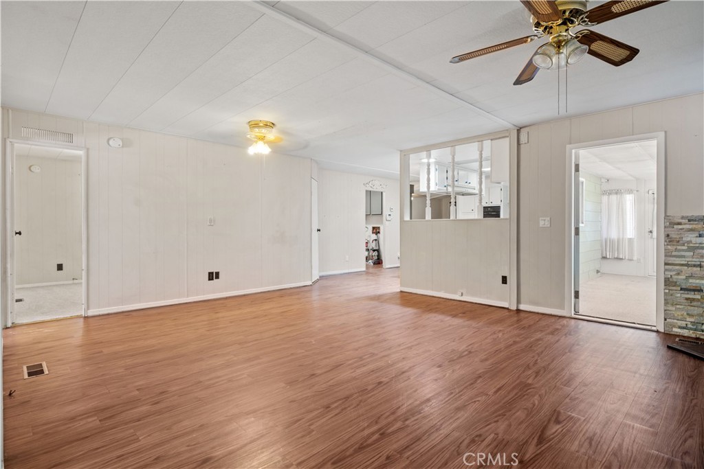 13393 Mariposa Road, Unit 169 Victorville, CA 92395 - Photo 13 of 36 wooden floor in an empty room with a window