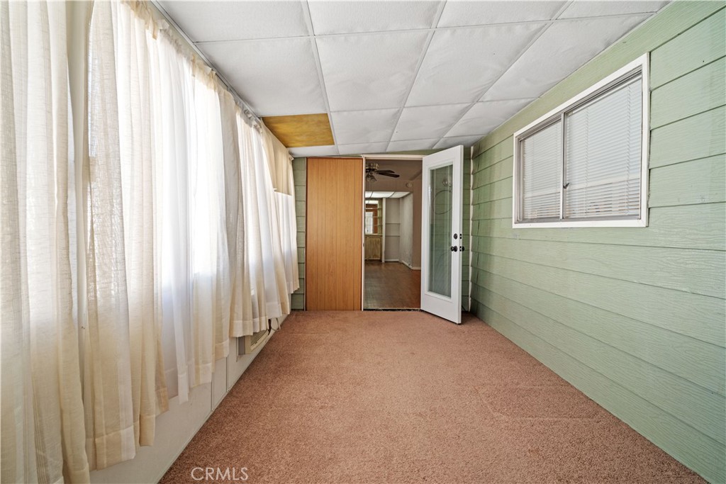 13393 Mariposa Road, Unit 169 Victorville, CA 92395 - Photo 15 of 36 a view of a hallway with wooden staircase