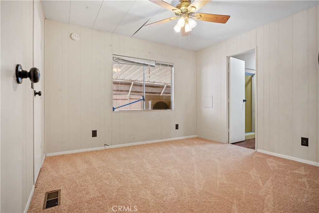 13393 Mariposa Road, Unit 169 Victorville, CA 92395 - Photo 20 of 36 an empty room with windows and fan