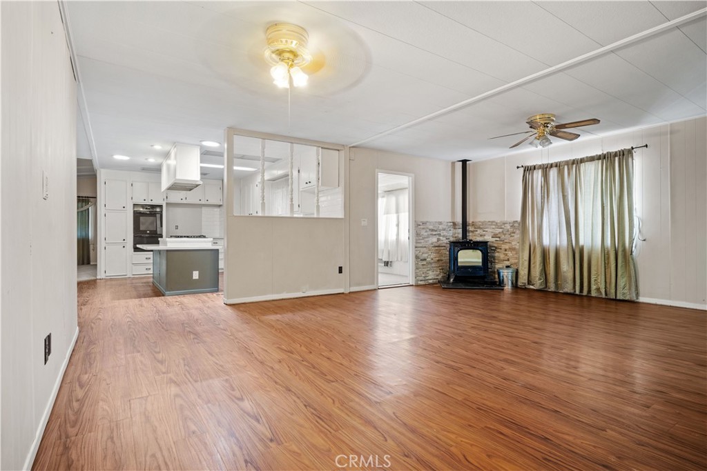 13393 Mariposa Road, Unit 169 Victorville, CA 92395 - Photo 21 of 36 a view of a kitchen with furniture and wooden floor