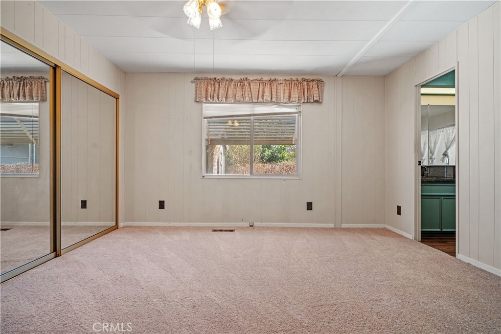 13393 Mariposa Road, Unit 169 Victorville, CA 92395 - Photo 22 of 36 an empty room with windows and closet