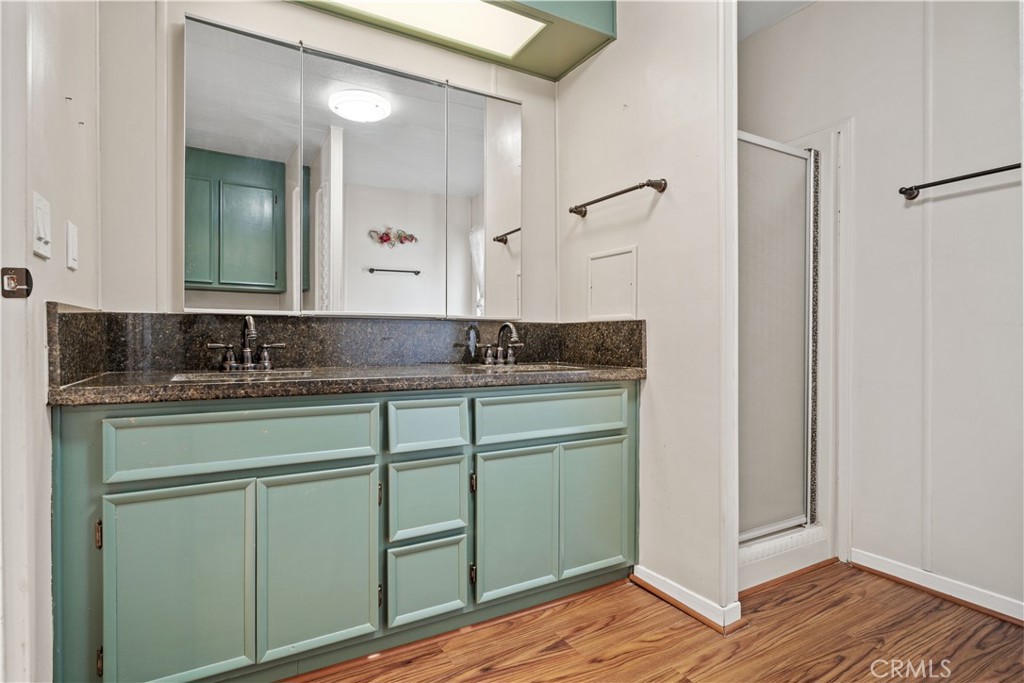 13393 Mariposa Road, Unit 169 Victorville, CA 92395 - Photo 25 of 36 a bathroom with a granite countertop sink and a mirror