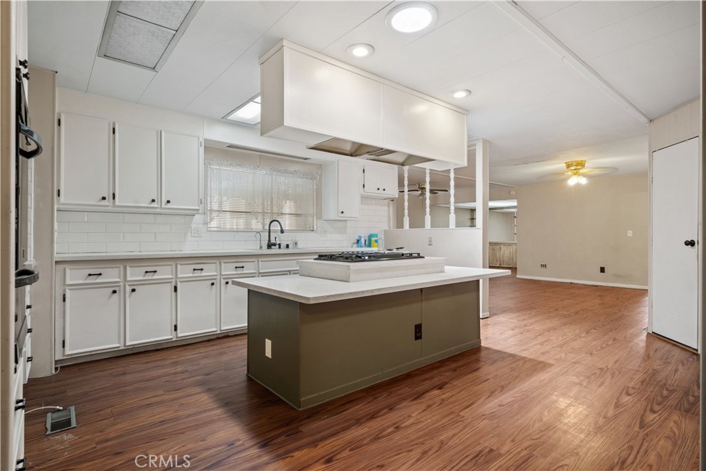 13393 Mariposa Road, Unit 169 Victorville, CA 92395 - Photo 3 of 36 a large kitchen with kitchen island a sink stainless steel appliances and cabinets