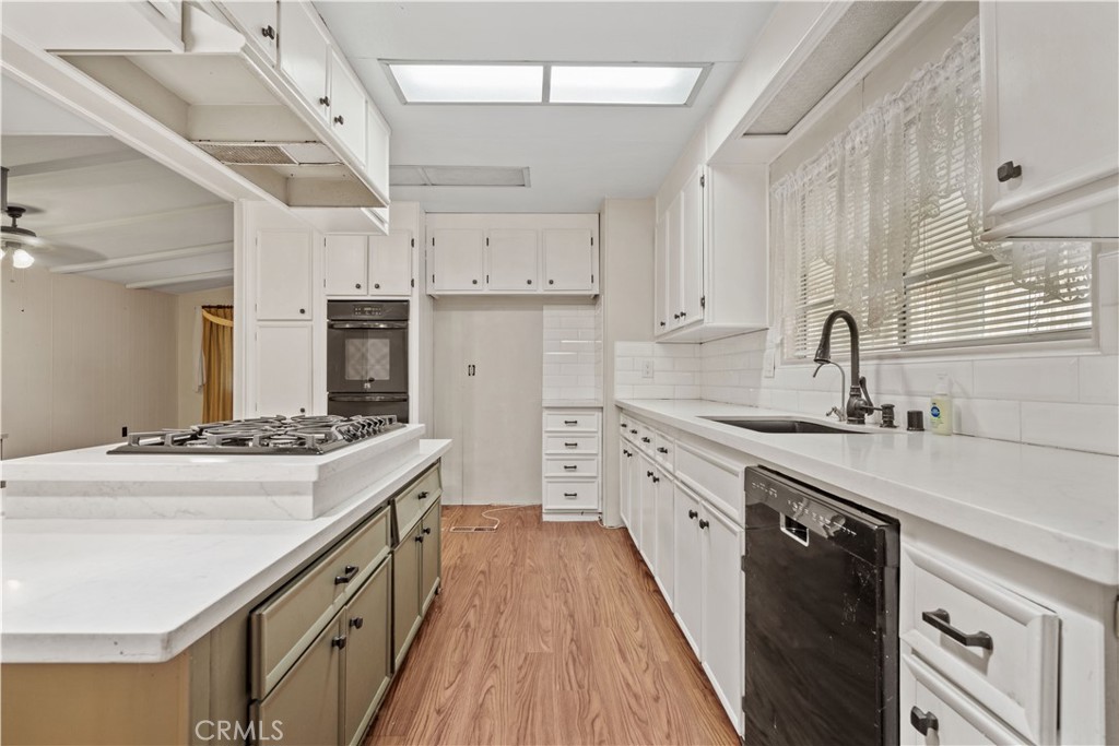13393 Mariposa Road, Unit 169 Victorville, CA 92395 - Photo 7 of 36 a kitchen with stainless steel appliances a sink stove and cabinets