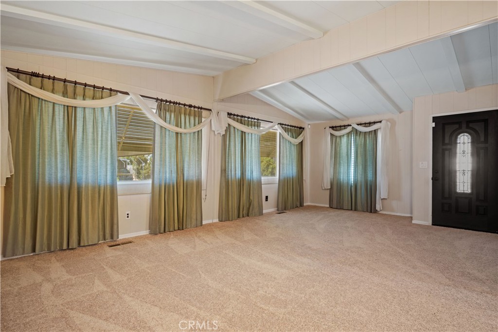 13393 Mariposa Road, Unit 169 Victorville, CA 92395 - Photo 10 of 36 a view of an empty room with wooden floor and a window