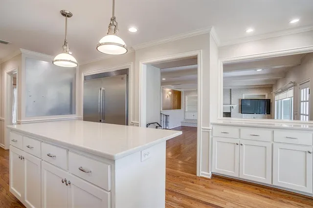 a large kitchen with granite countertop lots of counter space and a sink