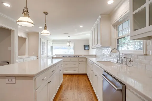 a kitchen with stainless steel appliances granite countertop a stove and a sink