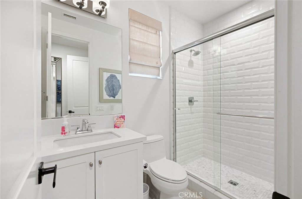 30 Windwalker Way Tustin, CA 92782 - Photo 12 of 22 a bathroom with a shower sink vanity mirror and toilet