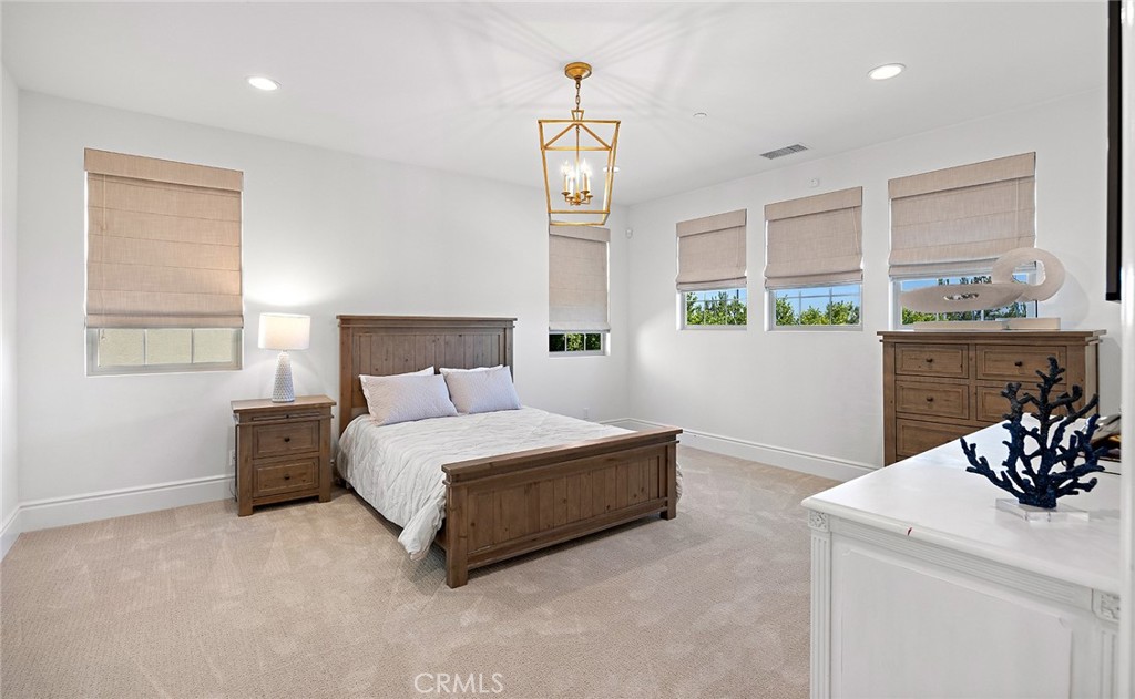 30 Windwalker Way Tustin, CA 92782 - Photo 13 of 22 a spacious bedroom with a bed and a chandelier