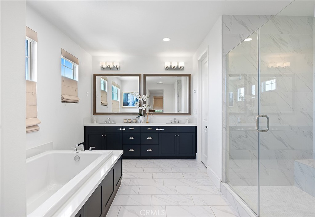30 Windwalker Way Tustin, CA 92782 - Photo 14 of 22 a spacious bathroom with a tub sink shower and mirror