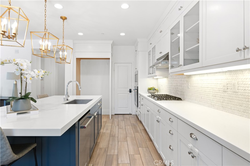 30 Windwalker Way Tustin, CA 92782 - Photo 4 of 22 a kitchen with sink cabinets and wooden floor