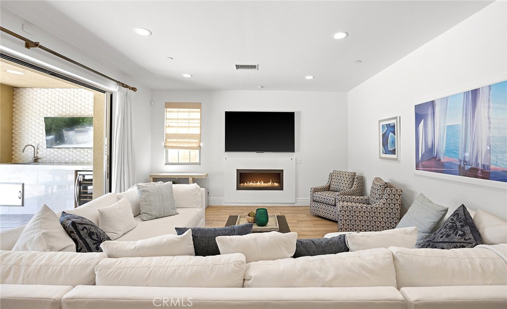 30 Windwalker Way Tustin, CA 92782 - Photo 7 of 22 a living room with furniture and a flat screen tv