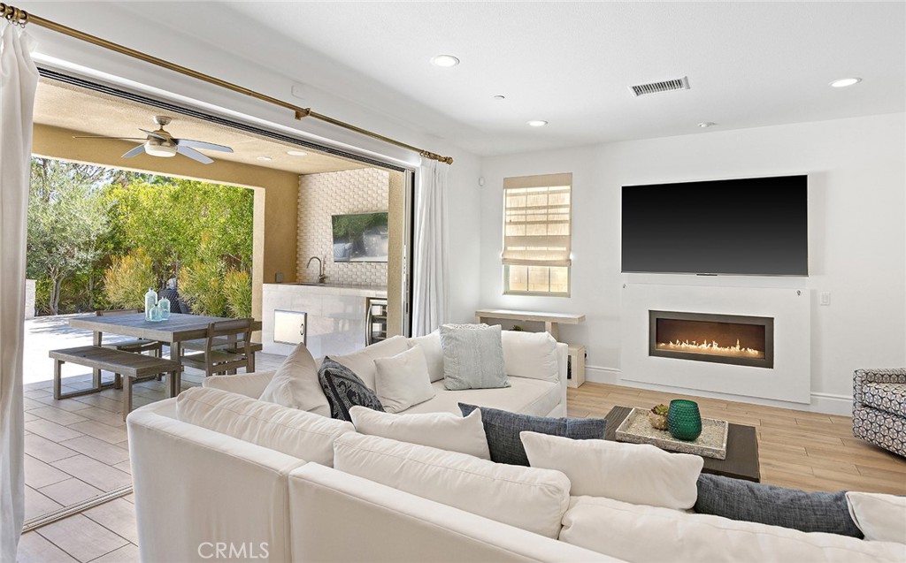30 Windwalker Way Tustin, CA 92782 - Photo 8 of 22 a living room with furniture a large window and a flat screen tv