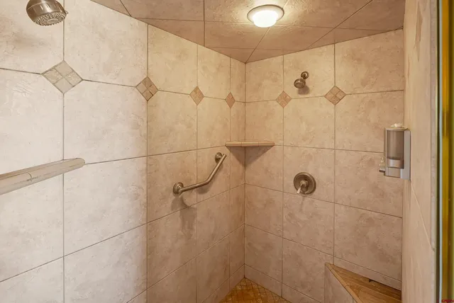 a bathroom with a shower curtain and a toilet