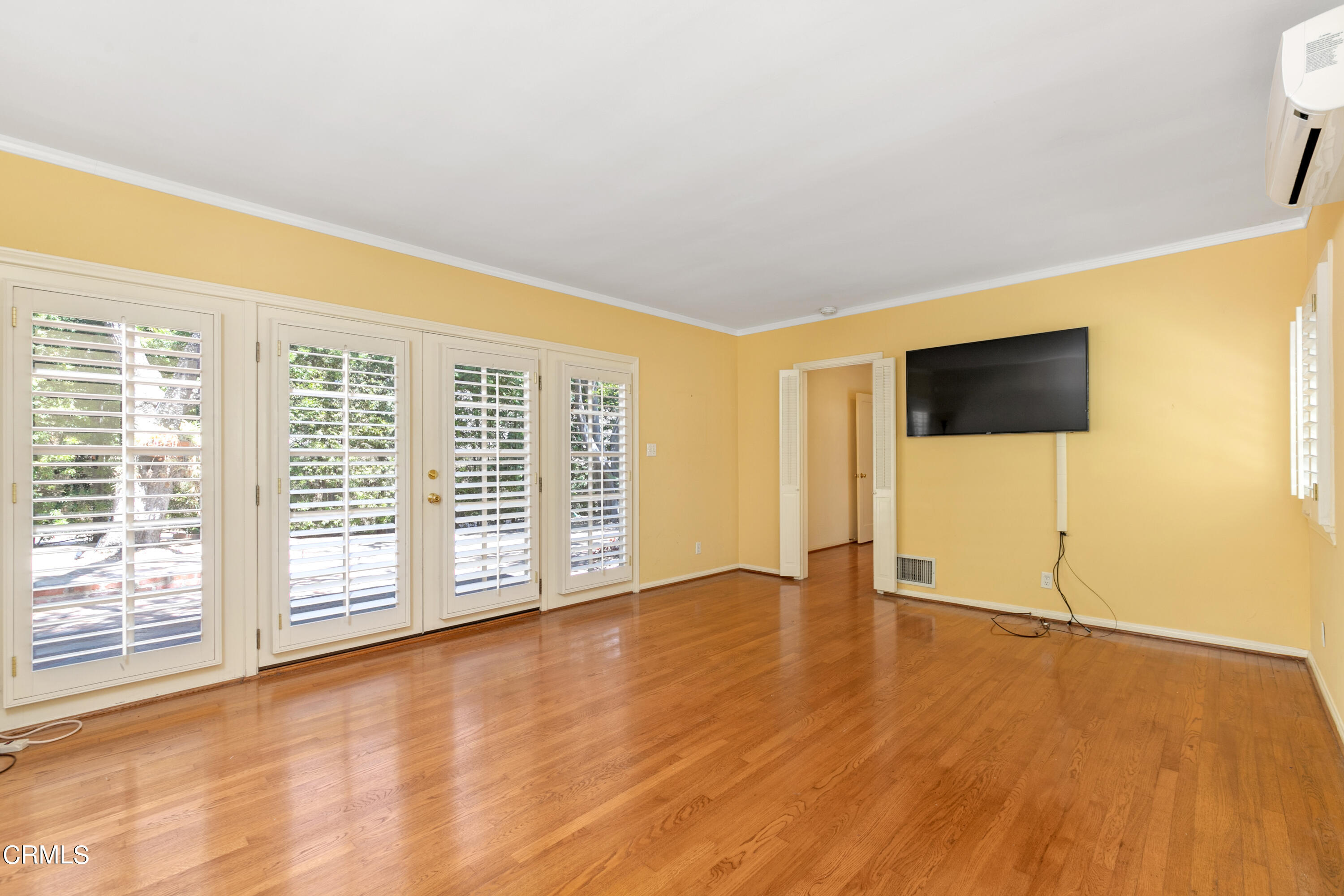 939 Old Mill Road Pasadena, CA 91108 - Photo 19 of 41 a view of an empty room with wooden floor and a window