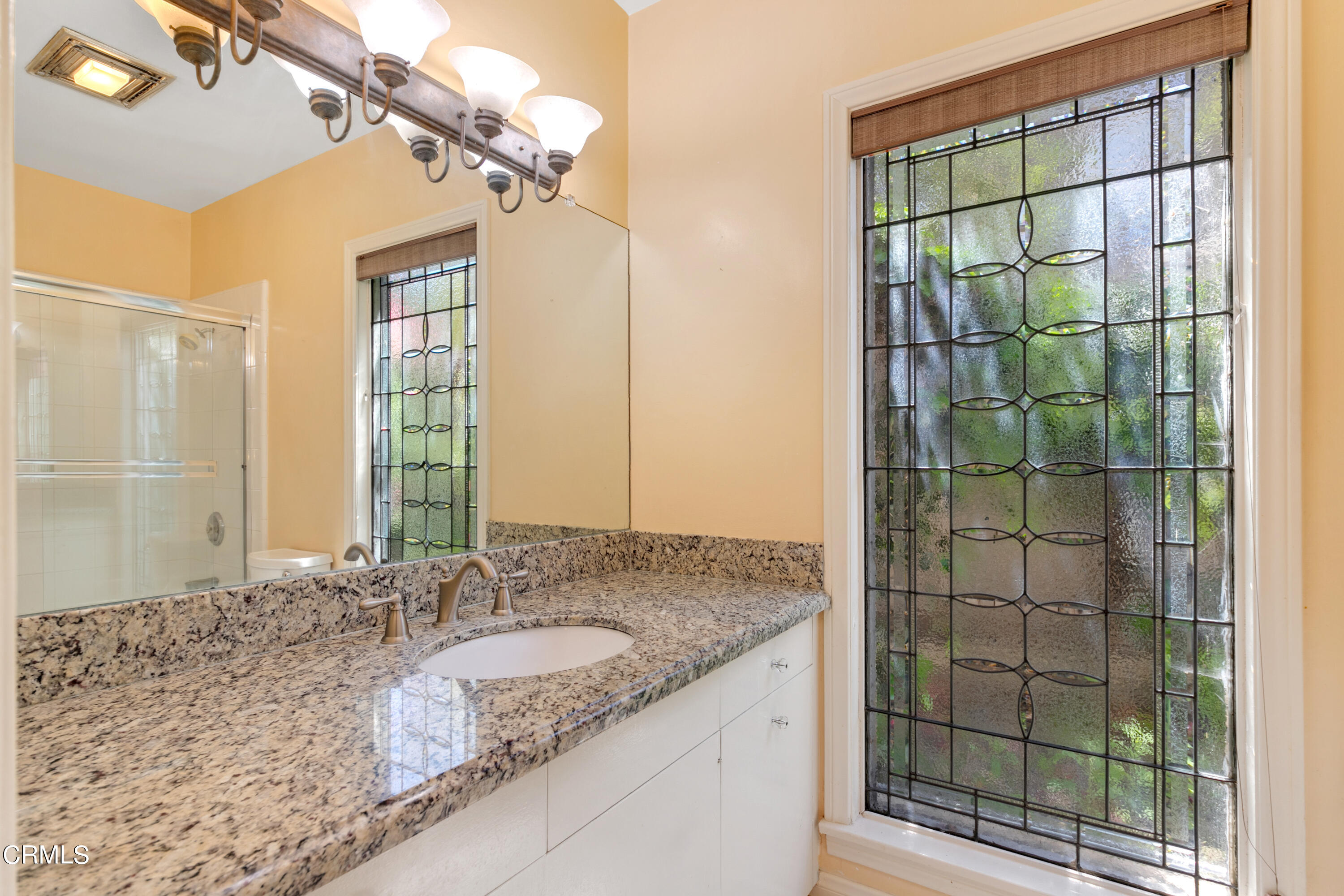 939 Old Mill Road Pasadena, CA 91108 - Photo 22 of 41 a bathroom with a granite countertop sink a mirror and shower