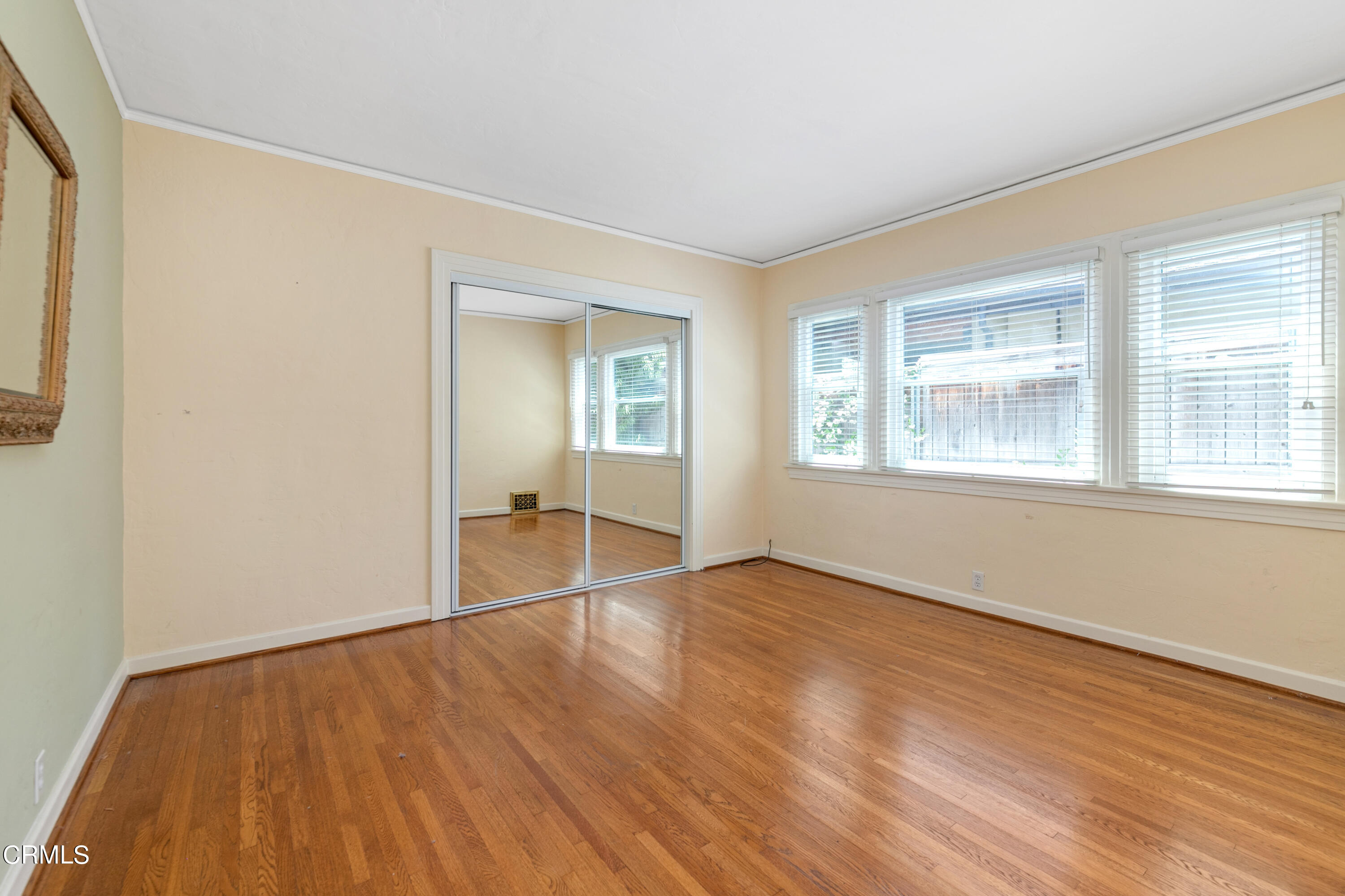 939 Old Mill Road Pasadena, CA 91108 - Photo 30 of 41 an empty room with wooden floor and windows