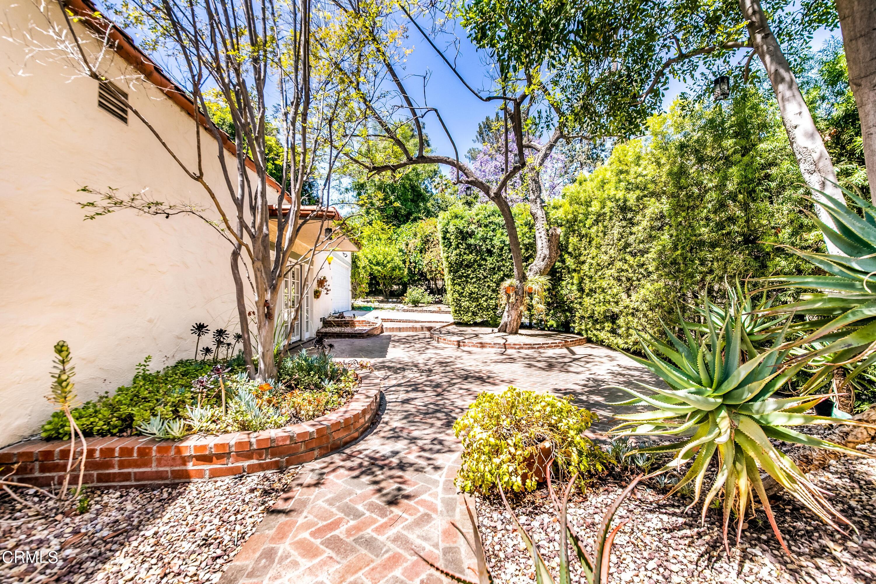 939 Old Mill Road Pasadena, CA 91108 - Photo 35 of 41 a view of a backyard with potted plants and large trees