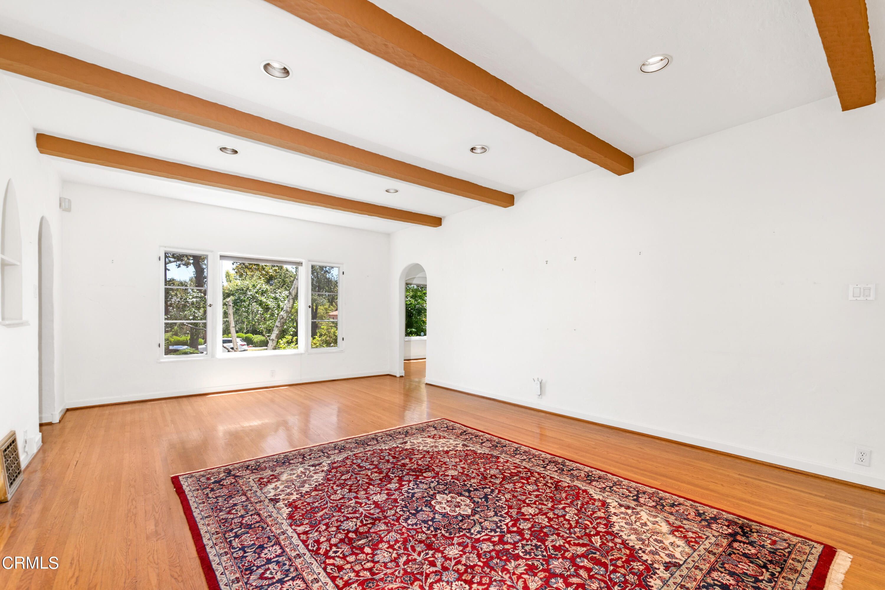 939 Old Mill Road Pasadena, CA 91108 - Photo 4 of 41 a view of an empty room with a window and wooden floor
