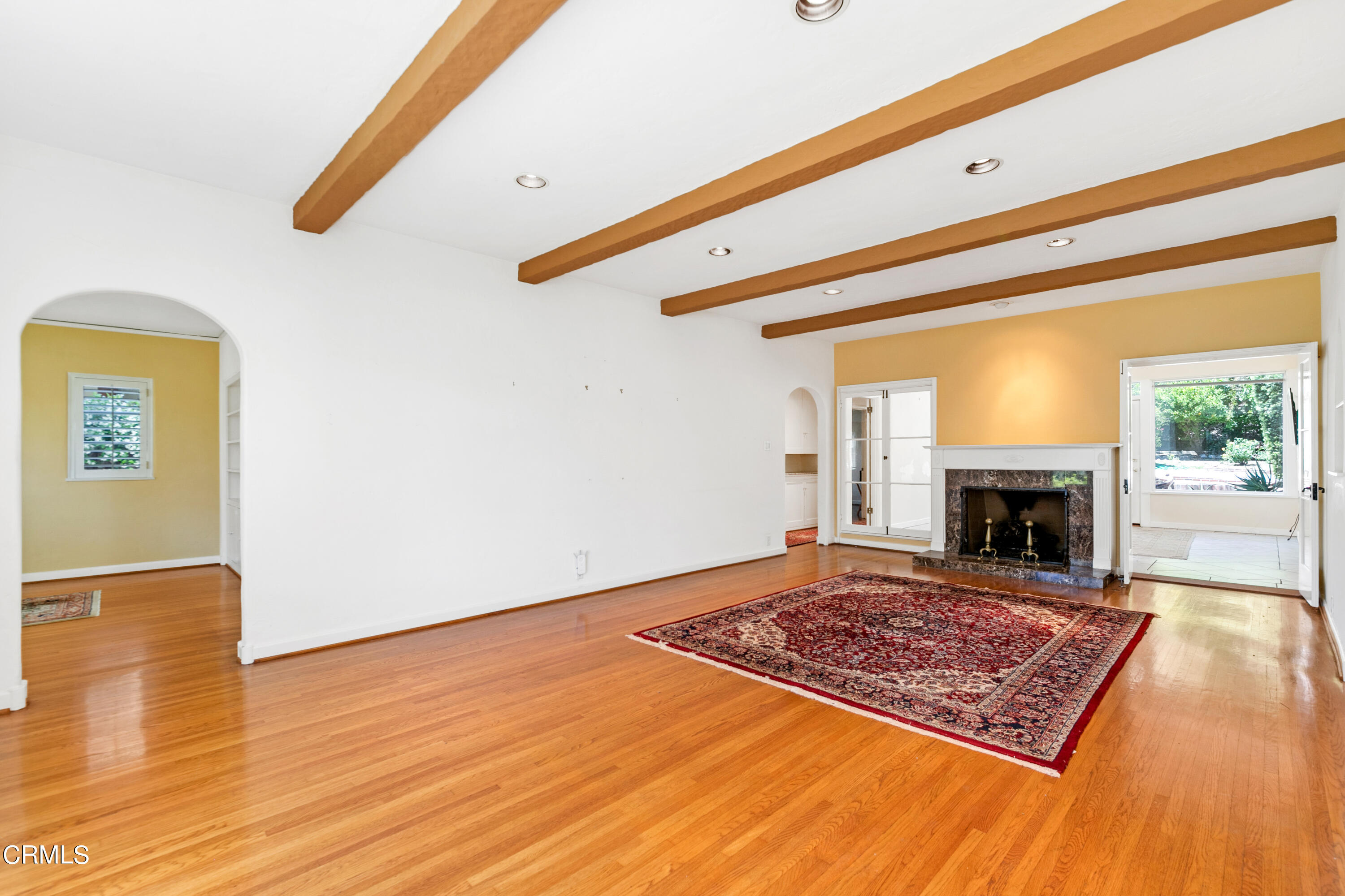 939 Old Mill Road Pasadena, CA 91108 - Photo 8 of 41 a view of an empty room with wooden floor fireplace and a window