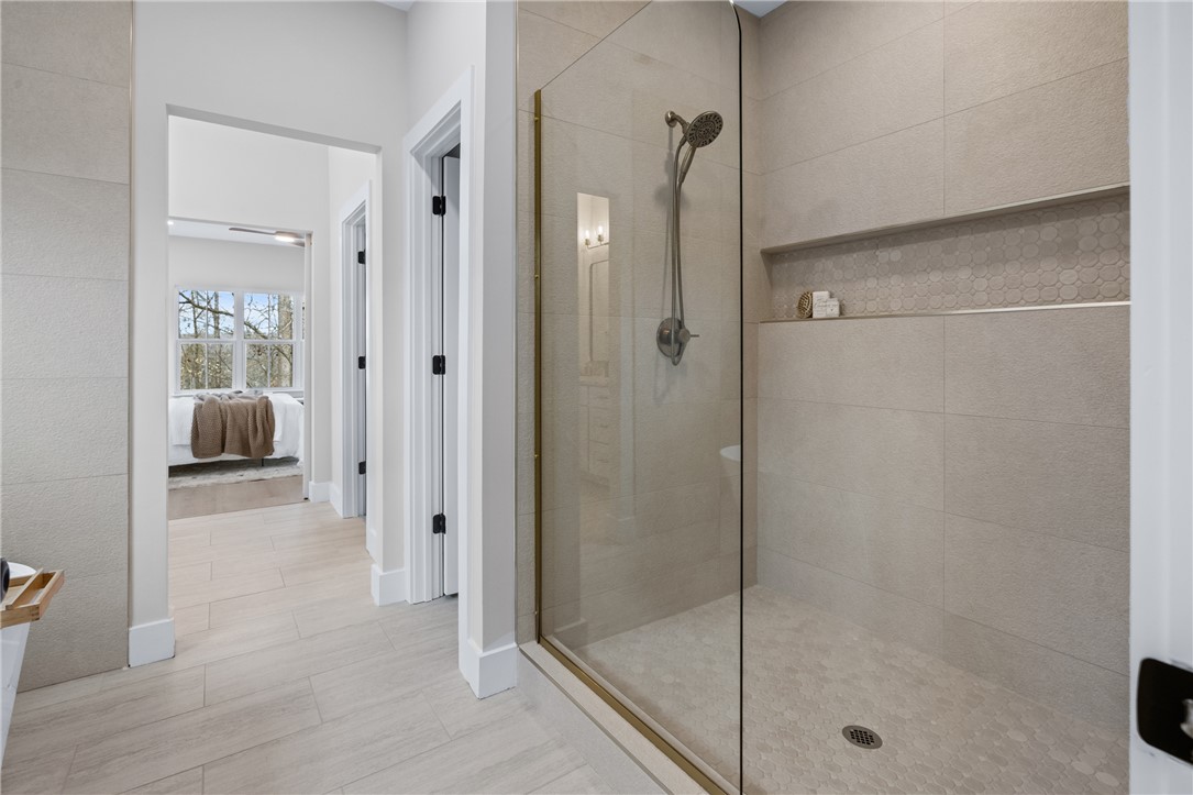 322 Oconee Avenue Westminster, SC 29693 - Photo 15 of 43 This modern bathroom features a spacious walk-in shower and elegant tile flooring.
