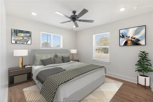 a bedroom with a bed and a potted plant