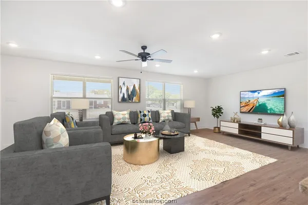 a living room with furniture and a flat screen tv