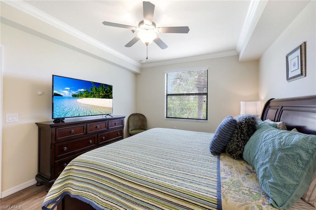 Undisclosed Address Naples, FL 34113 - Photo 13 of 24 a bedroom with a bed and a flat tv screen on dresser