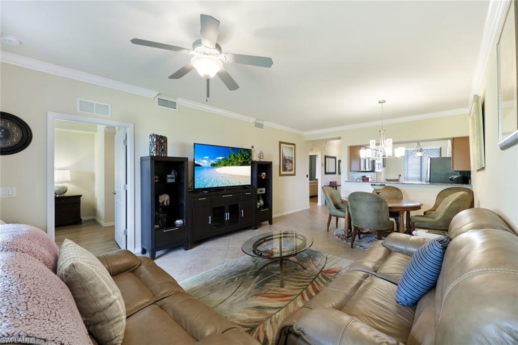 Undisclosed Address Naples, FL 34113 - Photo 4 of 24 a living room with furniture and a flat screen tv
