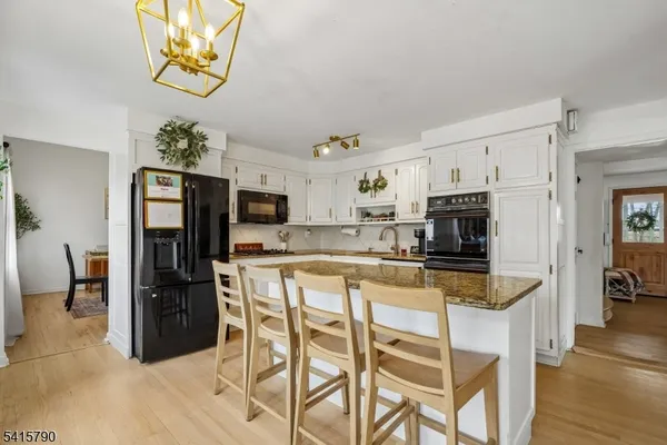 a kitchen with stainless steel appliances granite countertop a refrigerator and microwave