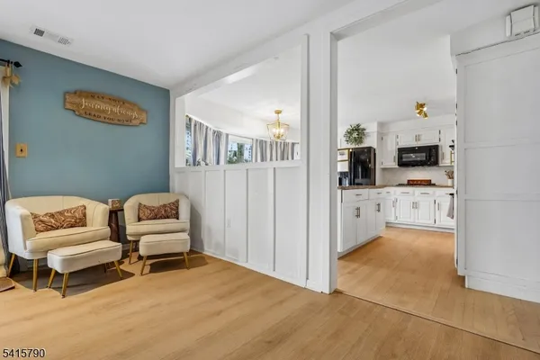 a view of a livingroom with furniture and a flat screen tv