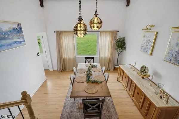 a bathroom with a granite countertop sink a mirror and a toilet