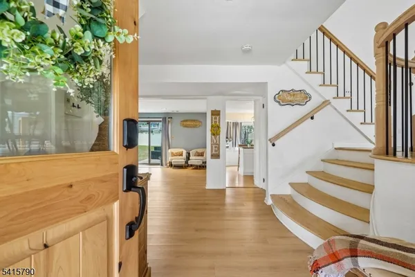 a view of an entryway with wooden floor and a livingroom view