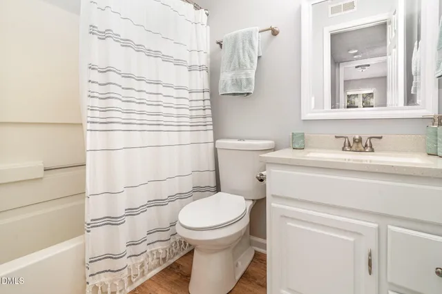 a bathroom with a toilet sink and shower