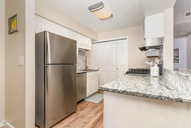 a kitchen with a refrigerator and a sink
