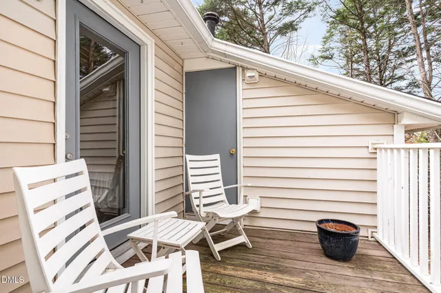 a view of a patio with a table and chairs and wooden floor