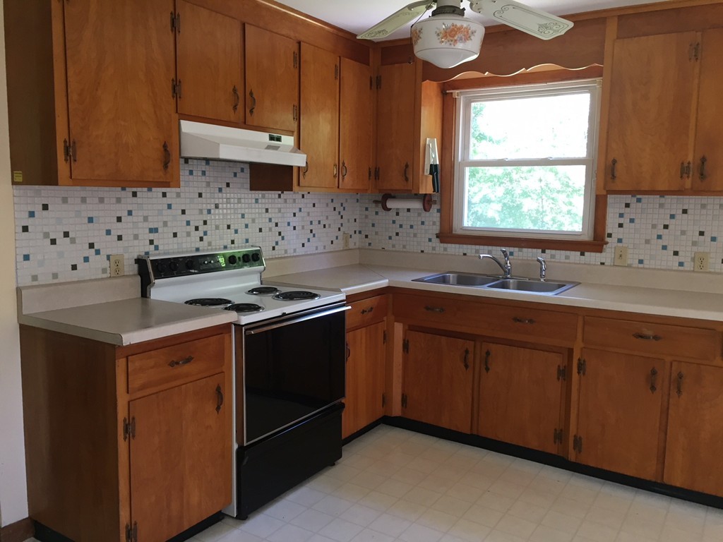 70 Bellflower Road Billerica, MA 01821 - Photo 4 of 23 a kitchen with a sink cabinets and window
