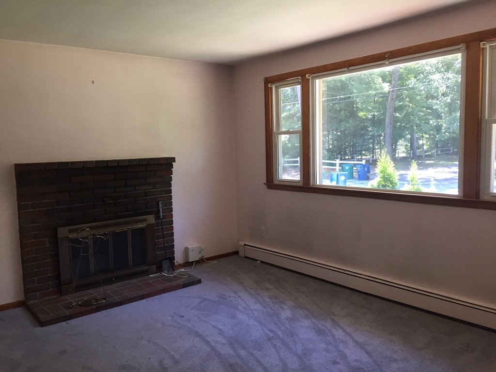 70 Bellflower Road Billerica, MA 01821 - Photo 7 of 23 wooden floor fire place and windows in a room