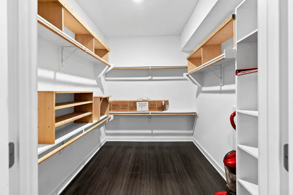 a view of walk in closet with empty racks