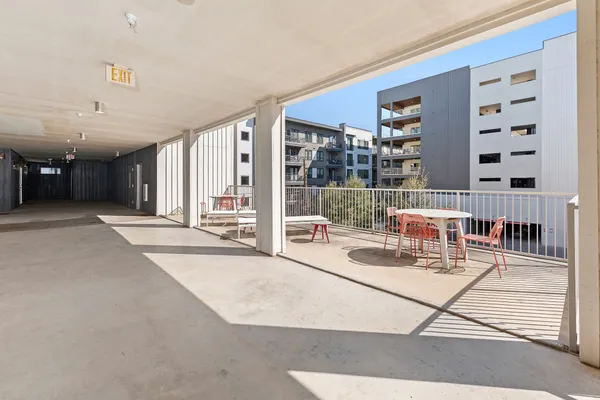 a living room with furniture a flat screen tv and a floor to ceiling window