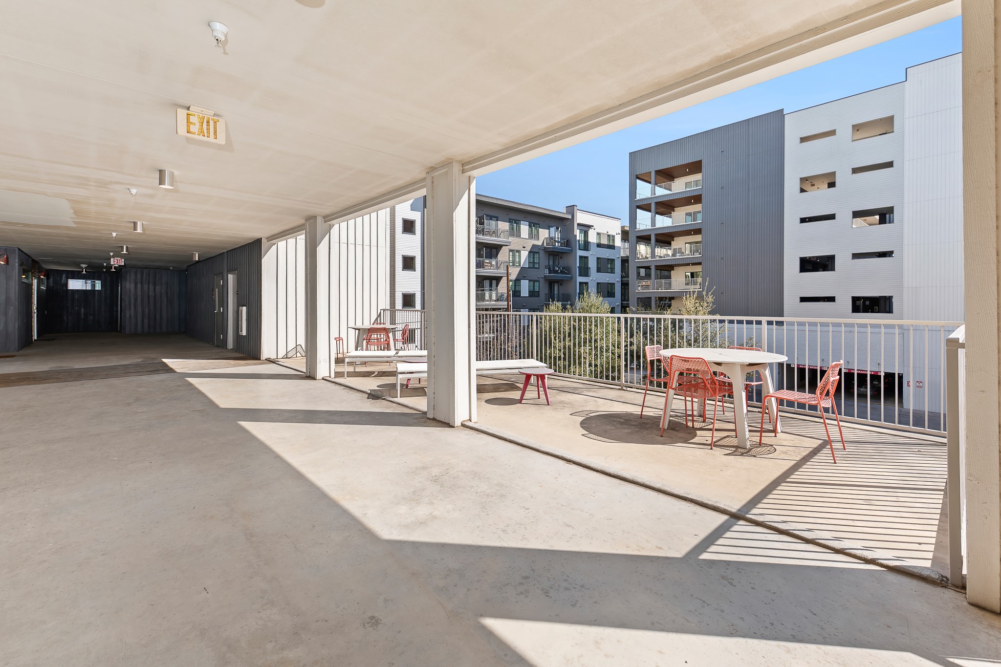 4361 South Congress Avenue, Unit 301 Austin, TX 78745 - Photo 22 of 40 a living room with furniture a flat screen tv and a floor to ceiling window
