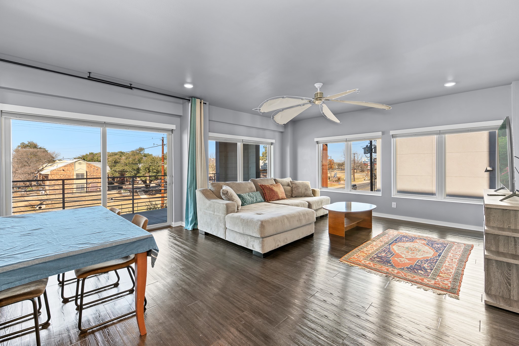 4361 South Congress Avenue, Unit 301 Austin, TX 78745 - Photo 5 of 40 a living room with furniture floor to ceiling window wooden floor and a table