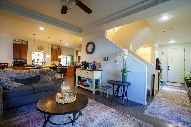 a living room with furniture and kitchen view
