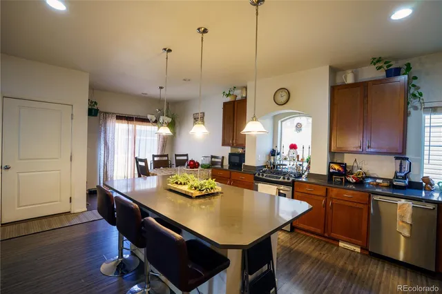 a kitchen with a table chairs and white cabinets